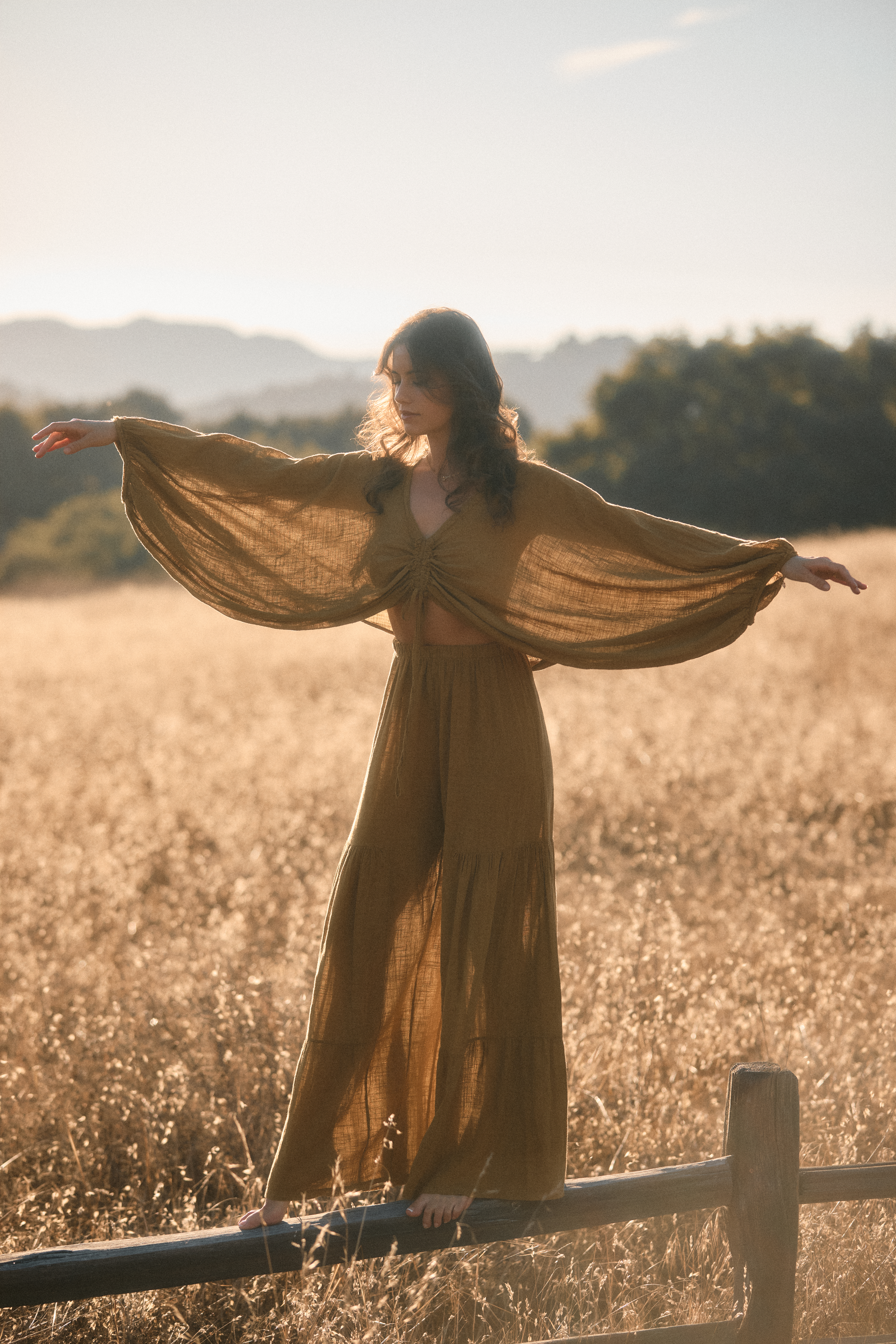 Taylor Ann Trad in a golden field at sunset